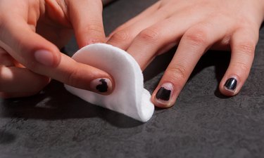 Close-Up Of Woman Removing Nail Polish