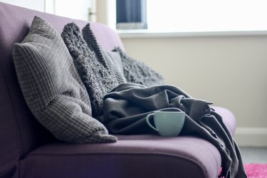 sofa with cushions and blankets