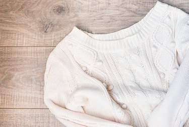 Women's autumn, winter clothes - white knitted pullover oversize, top view. Flat lay.