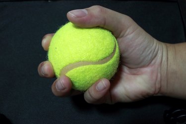 Close-Up Of Human Hand Holding Tennis Ball