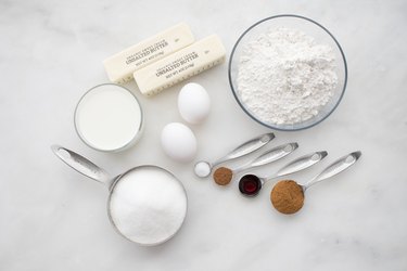 Ingredients laid out in measuring cups and spoons to make cinnamon muffins