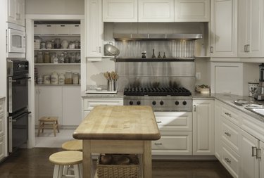 Wooden island with stools in kitchen