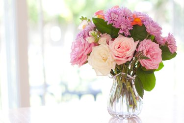 Bouquet of flowers on table near window