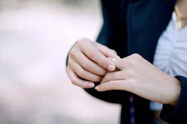 Midsection Of Woman Holding Ring On Finger