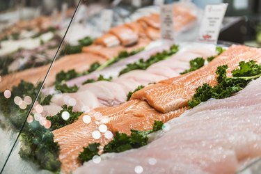 Seafood stand with cuts and filets of salmon and tuna