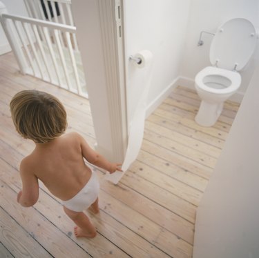 Boy Standing by Toilet