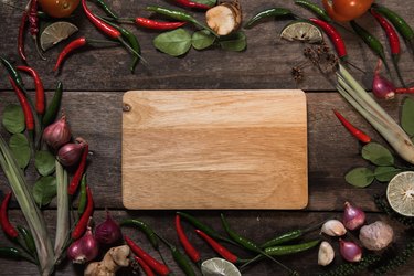 Directly Above View Of Cutting Board Amidst Vegetables On Table