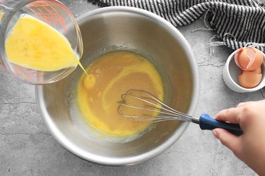 Add eggs while whisking