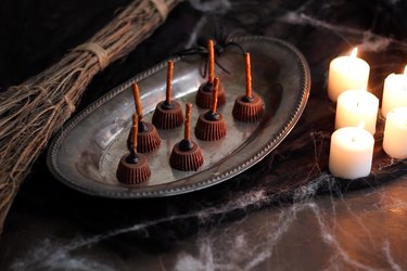 DIY witches' broom desserts made from peanut butter cups and pretzels