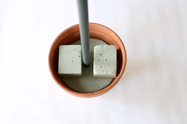 PVC pipe inserted into floral foam inside terra cotta pot