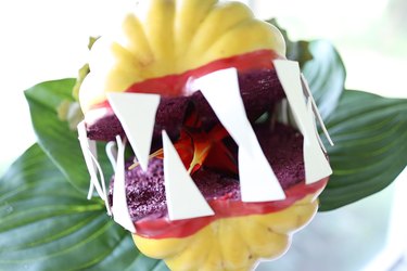 Bird of paradise flower inserted inside pumpkin to look like a plant tongue