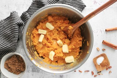 Add butter to sweet potatoes