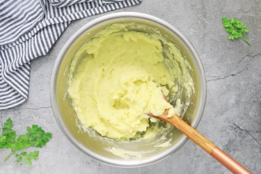 Add milk, butter, and salt to mashed potatoes