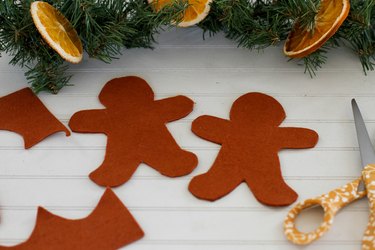 Cut out two gingerbread men from felt