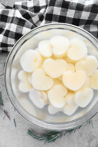 Add potatoes to a bowl of water