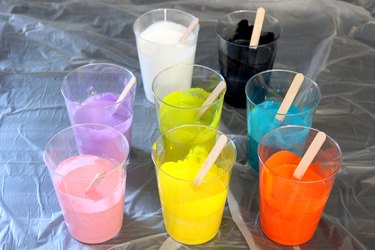 several cups of colorful paint