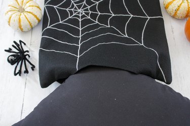 This not so itsy-bitsy spider DIY web pillow will create that spooky vibe you're going for.