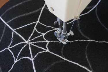 This not so itsy-bitsy spider DIY web pillow will create that spooky vibe you're going for.