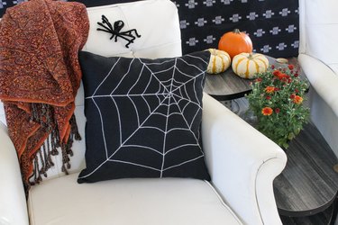 This not so itsy-bitsy spider DIY web pillow will create that spooky vibe you're going for.