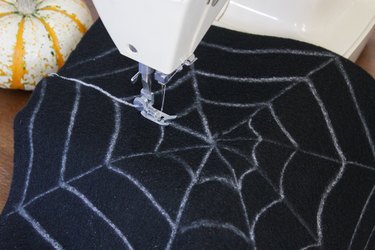 This not so itsy-bitsy spider DIY web pillow will create that spooky vibe you're going for.