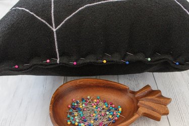 This not so itsy-bitsy spider DIY web pillow will create that spooky vibe you're going for.