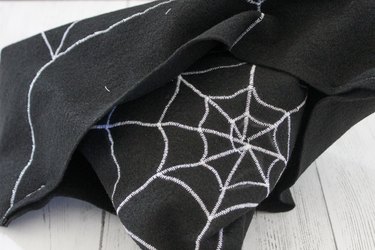 This not so itsy-bitsy spider DIY web pillow will create that spooky vibe you're going for.