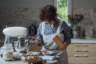 Making Chocolate Chip Cookies: Woman Adding Cocoa to the Flour Mixture