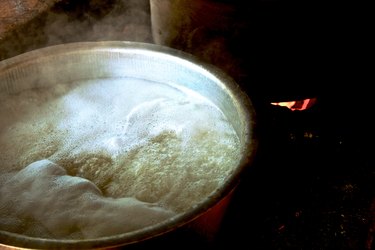 Boiling water with rice in large pot