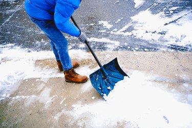 Man Shovels Snow From Driveway After Winter Storm