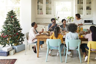 Family and friends talking while enjoying meal