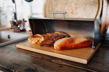 Loaves of bread in a metal and wood bread box