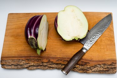 Cut up large Sicilian Eggplant on cutting board, Santoku Knife on the side