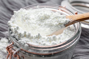 Container of corn flour with wood spoon