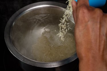 Pouring rice into hot water