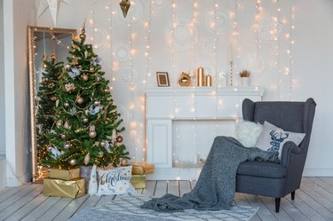 Modern design room in light colors decorated with Christmas tree and decorative elements