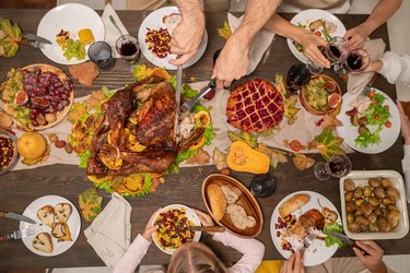 Family eating tasty festive food at table