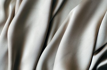 Background with a beautiful wavy silver fabric.