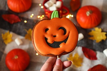 Funny Jack O Lanterns pumpkin shaped cookie for Halloween. Selective focus. Top view