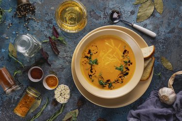 Bowl of soup accompanied by white wine