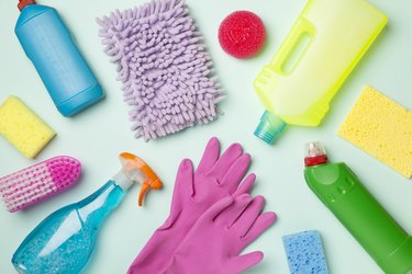 Many different house cleaning products on color background