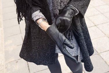 close-up of woman putting on her gloves