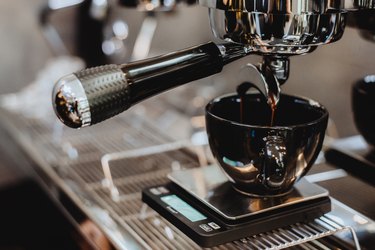 Coffee machine preparing cup of coffee.