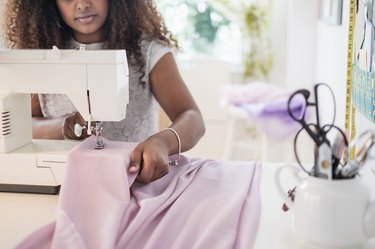 Black woman using sewing machine