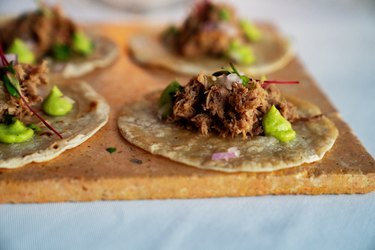 Beautifully Styled Shredded Beef Tacos On Corn Tortillas With Dots Of Guacamole