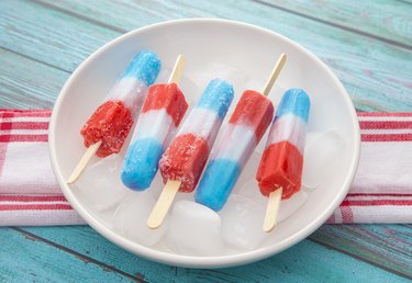 Red, white and blue ice pops in a bowl of ice