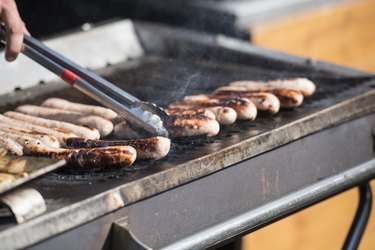 Sausages cooking on a griddle