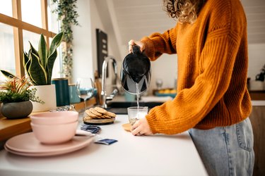 woman pouring tea kettle