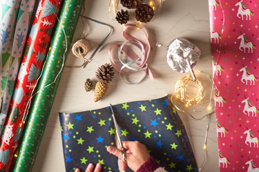 Woman wrapping gifts at home