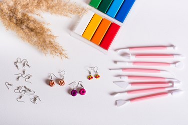 Ready-made polymer clay earrings and tools for work. Handmade and leisure. Top view.