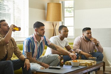 Soccer fans watching match on TV at home